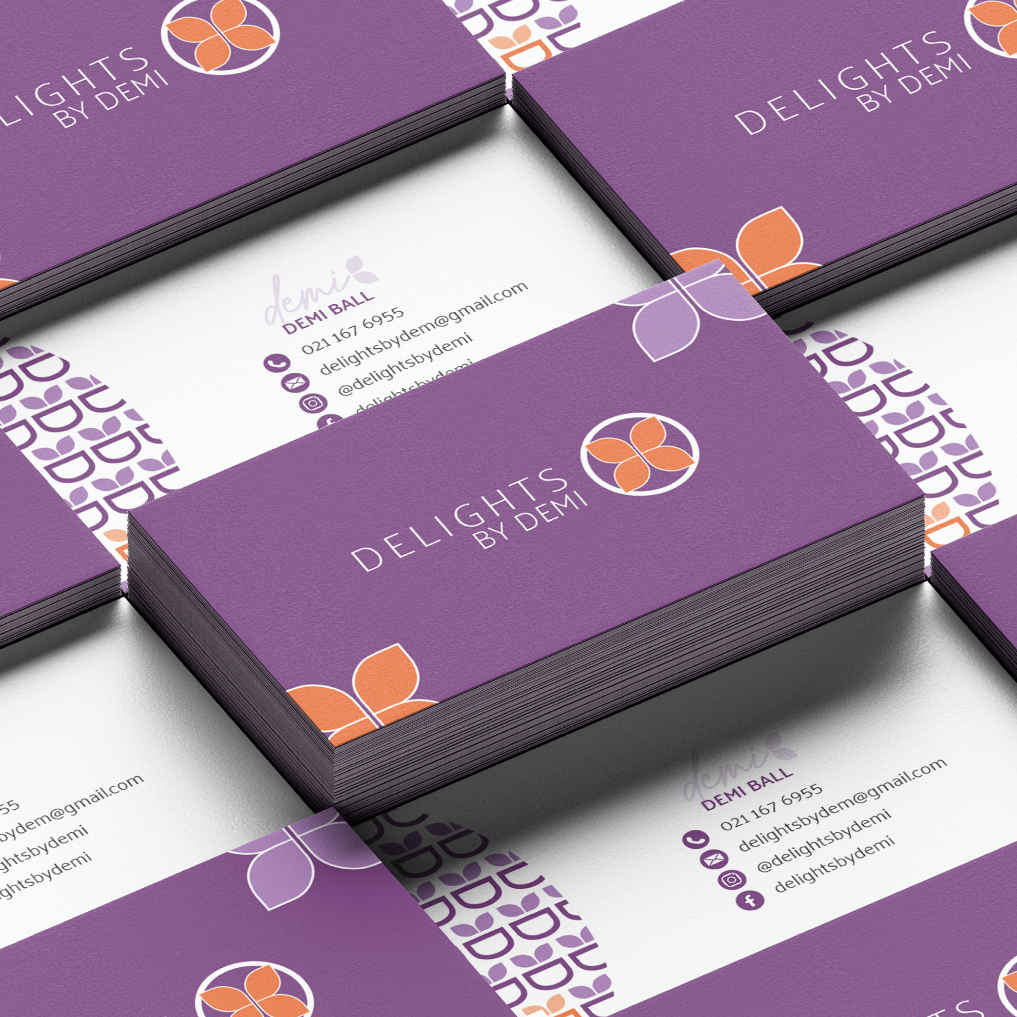 A set of business cards with purple and orange flowers on them.